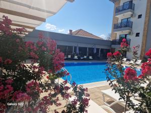a view of the pool at a hotel with pink flowers at Villa Mystic in Ohrid