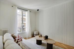 a living room with a couch and a coffee table at VINCENNES Luxury flat L005 in Vincennes +8 photos