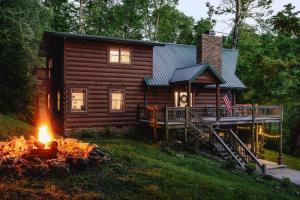 a log cabin with a fire in front of it at Pinewood Chalet in Smithville