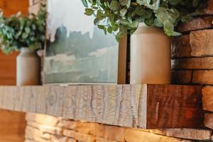a wooden shelf with two potted plants on it at Pinewood Chalet in Smithville