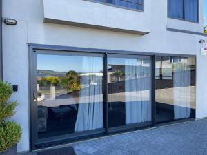 a building with sliding glass doors with a view at Beautiful Lakeview Apartment in Taupo
