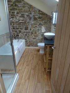 a bathroom with a sink and a tub and a toilet at Hollamoor Farm in Barnstaple