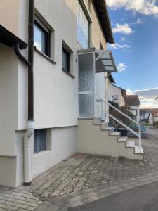 a building with stairs on the side of it at Weitblick in Niederkirchen bei Deidesheim
