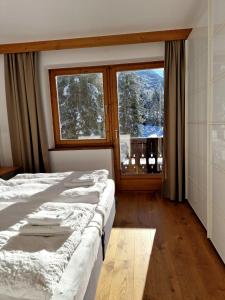 A bed or beds in a room at Pension Baranekhof - accommodation in nature - Baranek Resorts