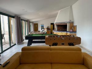 a living room with a couch and a pool table at Demeure de Charme de la Gravière in Mably