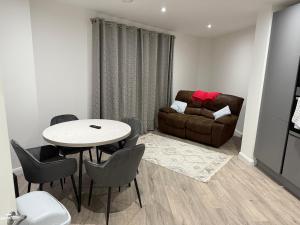 a living room with a table and a couch at Modern - City Centre - 2BR APT in Belfast