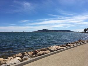a view of a large body of water with rocks at LE PARC , Balaruc les bains T2 clim PMR in Balaruc-les-Bains