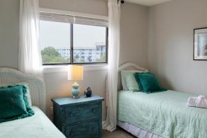 a bedroom with two beds and a window at half Mi to Beach Condo in Hilton Head Resort! in Hilton Head Island +25 photos