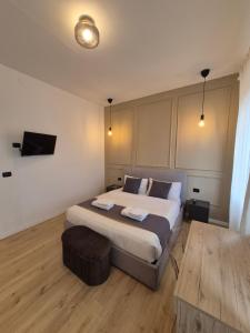 a bedroom with a large bed and a tv at Casa Enea - Luxury House Milano Navigli in Milan