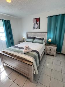 a bedroom with a bed with a teddy bear on it at Bel appartement N4 neuf de 2 chambres à Grand-Case in Grand Case