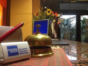 a gold bell sitting on a counter next to a box at Hotel Belvedere in Canicattì