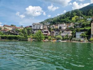 a town on the shore of a river with houses at Casa Andrea Panorama by Fewotessin in Gerra