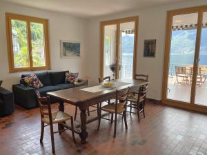 a living room with a table and chairs and a couch at Casa Andrea Panorama by Fewotessin in Gerra