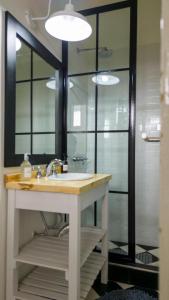 a bathroom with a sink and a shower with a mirror at Balcon de la virgen in Luján +9 photos