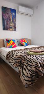a bed in a room with a zebra blanket on it at Villa on Sliema Promenade and ferries in Sliema