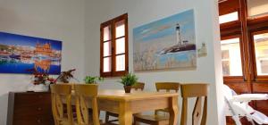 a dining room with a wooden table and chairs at Villa on Sliema Promenade and ferries in Sliema