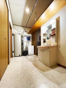 an empty kitchen with two refrigerators and a sink at 清里札弦Arun別邸 in Kiyosato