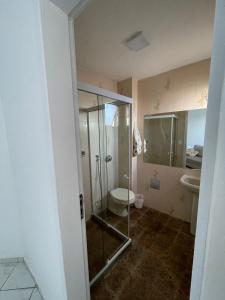 a bathroom with a shower and a toilet and a sink at Apartamento grande FRENTE MAR in Guarapari