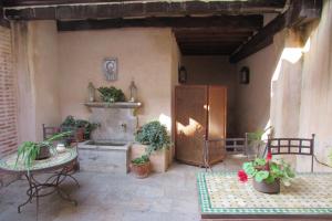a patio with a fountain and a table and chairs at Hotel Casa Morisca in Granada