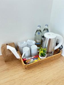 a basket with a tea kettle and other items on a table at ร เรือ รีสอร์ท in Ban Khao Noi
