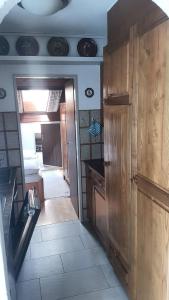 a kitchen with wooden cabinets and a counter top at Apartment Birkenstrasse 54 Engelberg in Engelberg