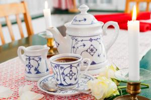 a table with a cup of coffee and a tea pot at Drifthuus 1 klein in Spiekeroog