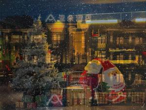 a window with a christmas tree and a city at Shanghai Atour Hotel On The Bund- People Square in Shanghai