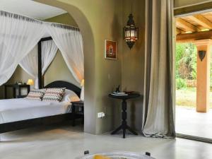 a bedroom with a canopy bed and a table at Holiday home with wooden-beamed patio in Santa Gertrudis de Fruitera +32 photos