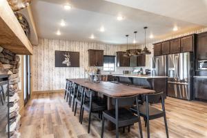 a kitchen with a large wooden table and chairs at Branson 10 Bedroom Lakeside Lodge! PRIVATE HEATED POOL! in Hollister