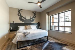 a bedroom with a bed with a deer mural on the wall at Branson 10 Bedroom Lakeside Lodge! PRIVATE HEATED POOL! in Hollister +63 photos