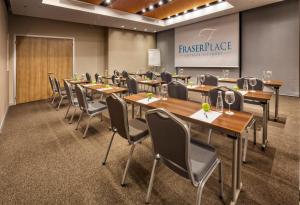 a conference room with tables and chairs and a projection screen at Fraser Place Antasya Istanbul in Istanbul