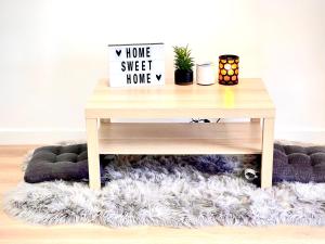 a wooden coffee table on a furry rug under a desk at Cozy Home Silicon Valley ROOM 3 in San Jose