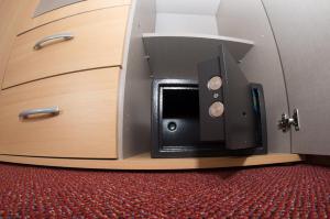 a microwave oven sitting inside of a wooden cabinet at Apartmán City Olomouc in Olomouc