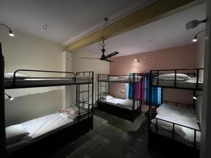 three bunk beds in a room with a ceiling at Rudra The Stay in Jaipur