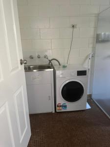 Bluff PointHarbour View Accommodation Unit 3的客房内的洗衣机和水槽