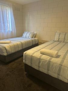 Bluff PointHarbour View Accommodation Unit 3的房间里有两张并排的床