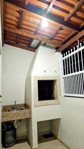 a bathroom with a sink in a room at Canto da Praia Aconchego in Penha