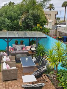 a patio with a table and chairs next to a pool at Albert Number 6 in Whitianga
