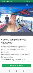 a man sitting on a boat in the water at Wanderley in Oiapoque