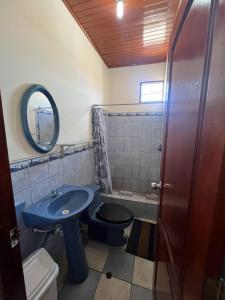a bathroom with a blue sink and a toilet at La Casa Verde in Iquitos +3 photos