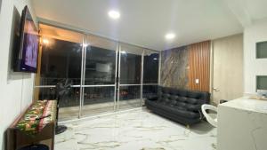 a living room with a couch and a large window at Apartamento Mirador la Estancia in Melgar