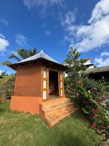 a small dog house sitting in the grass at Atabeba in Las Galeras +19 photos