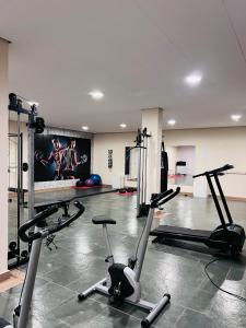 a gym with several exercise bikes in a room at Flat Piemonte Apart in Serra Negra
