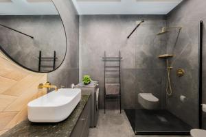 a bathroom with a sink and a mirror at Hanza Tower Apartment no 2210 - 22nd floor, swimming pool, jacuzzi, panorama view in Szczecin