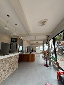 an open lobby with a bar and a stone wall at Rin Bay View Resort in Haad Rin +118 photos