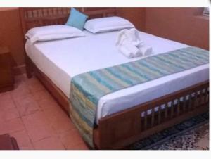 two beds with towels on top of them in a room at Karithanam Ayur Farms in Vaikom