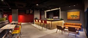 a restaurant with a bar and tables and chairs at Fraser Place Antasya Istanbul in Istanbul