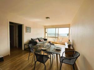 a living room with a table and chairs and a couch at Appartement Bénodet 4 pers, proche plage - FR-1-481-169 in Bénodet