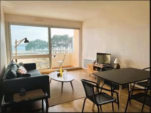 a living room with a couch and a table at Appartement Bénodet 4 pers, proche plage - FR-1-481-169 in Bénodet +11 photos