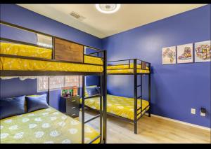 a room with two bunk beds and a blue wall at Indio Gateway-New Salt Water Pool and Spa in Indio +34 photos